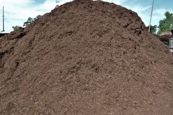 A pile of dirt on top of the ground.