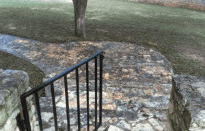 A stone path with steps leading to the top of stairs.