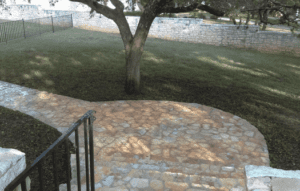 A stone walkway with steps leading to the top of stairs.