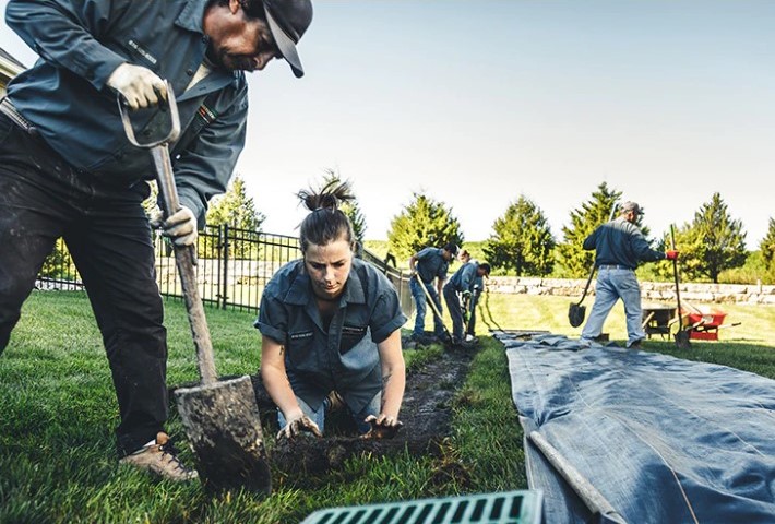 A group of people working on the ground.