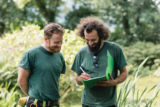 Two men planning ground works on estate